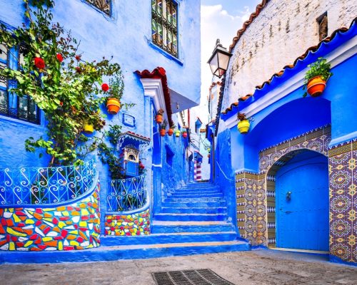 Chefchaouen,,Morocco.,Blue,Staircase,And,Wall,Decorated,With,Colorful,Flowerpots,